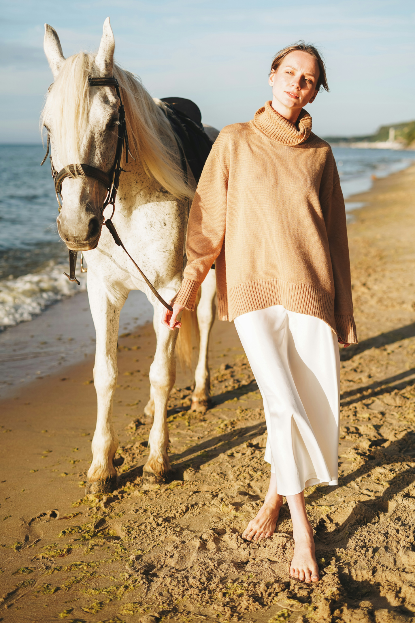 Woman and horse on beach